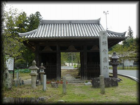 桜堂薬師（法明寺）境内正面に設けられた山門と石造寺号標と石燈籠