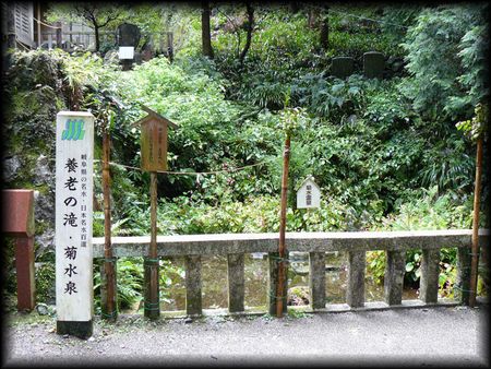菊水泉を石造玉垣越しに撮影した画像